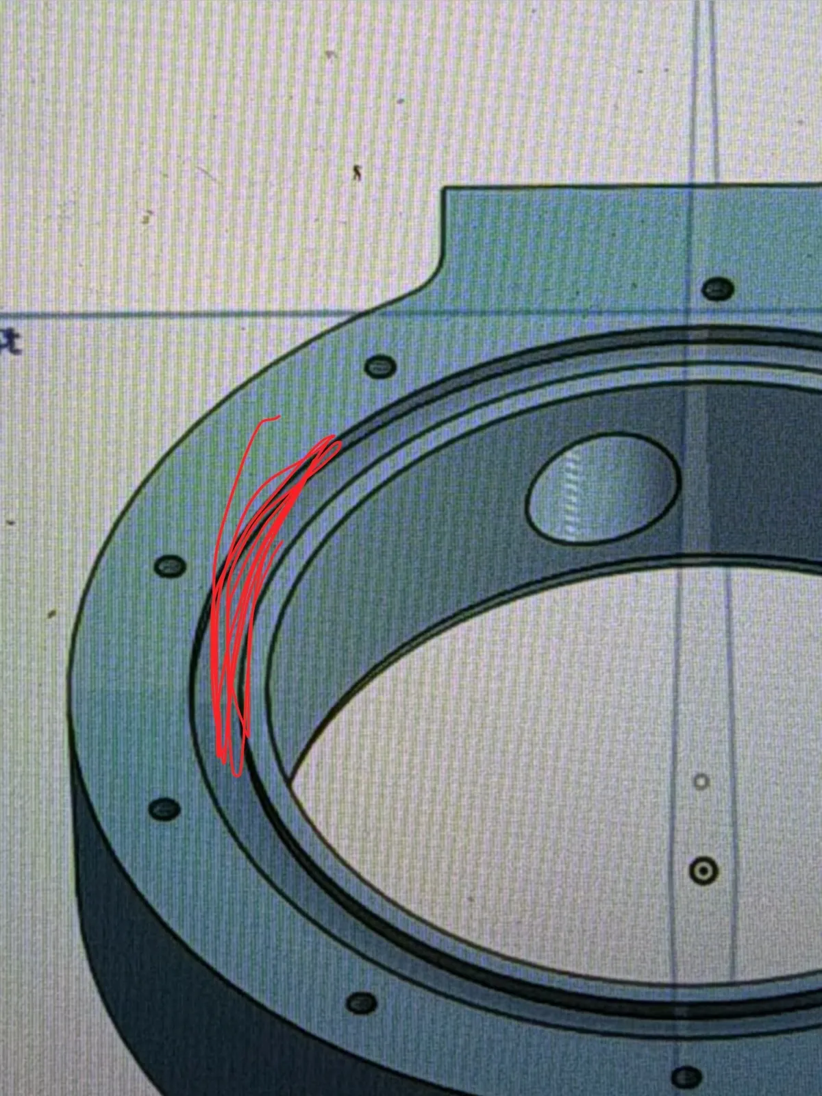 Photo of a screen with a CAD pump housing, offset bore and bolt holes; red marker scribble highlights one bore wall.